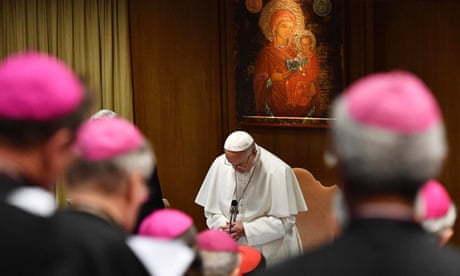 Pope Francis prays during the opening of a sex abuse prevention summit at the Vatican.