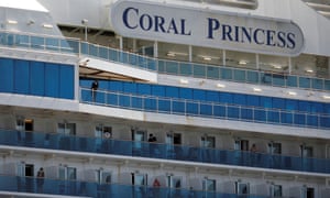 Passengers are seen aboard the Coral Princess ship as it docks in Miami, Florida Saturday.
