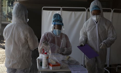 Healthcare workers prepare to test patients for Covid-19 at a facility in Johannesburg