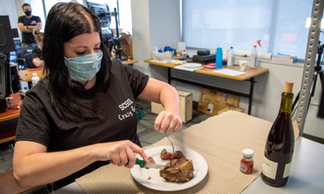 Heather Rendulic using a knife and fork with help from electrodes implanted in her neck, after she lost functional use of her left hand following as stroke in 2012.