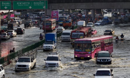 Traffic moves as floodwater takes over the streets in Bangkok in 2011.