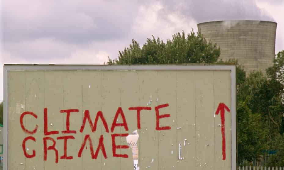 Climate change activists’ graffiti on a billboard near the Didcot coal-fired power station in Oxfordshire, UK.