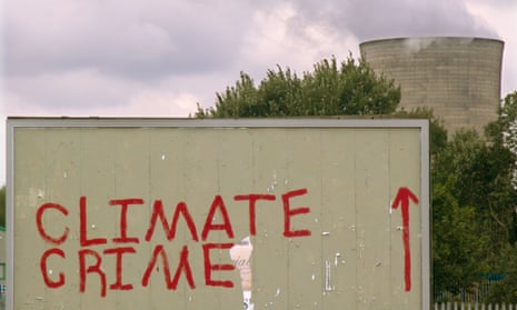 Climate change activists’ graffiti on a billboard near the Didcot coal-fired power station in Oxfordshire, UK.