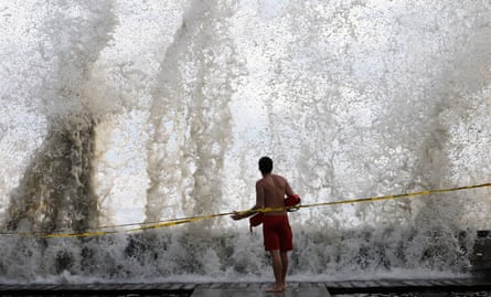 A person in front of a wave.