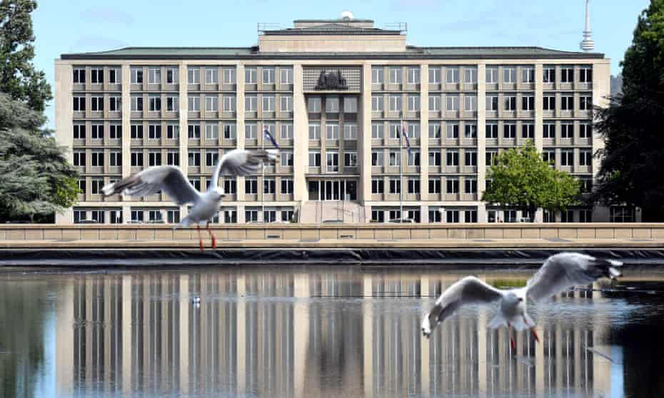 Seagulls fly past The Department of Treasury building in Canberra