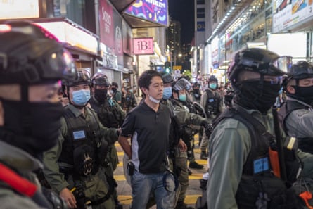 Ted Hui being led away by officers.