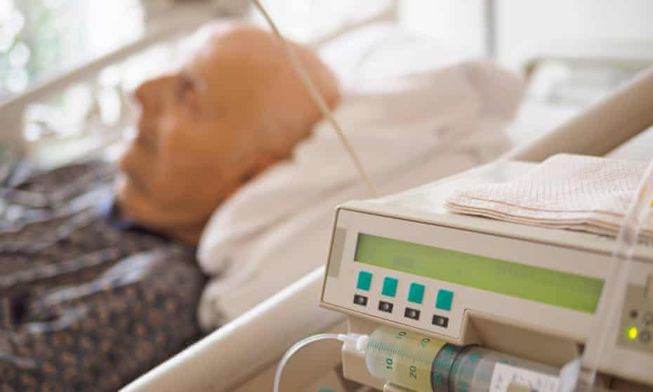 Senior man in bed in a palliative care unit.