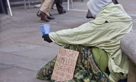 A homeless man begging on a street