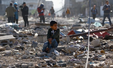 A Palestinian child sits among the rubble of homes destroyed in an Israeli strike in Khan Younis in the southern Gaza Strip.