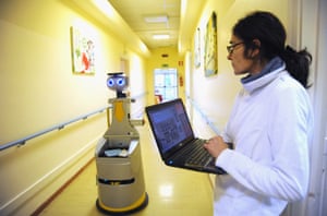 A caregiver controls Robot-Era’s movement using her laptop.