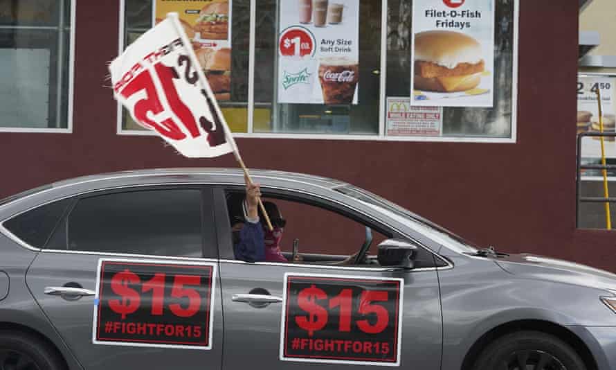 Fast-food workers drive though a McDonald’s restaurant demanding a for a $15 hourly minimum wage in east Los Angeles 