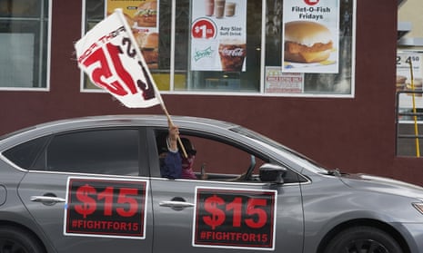 Fast-food workers drive though a McDonald's restaurant demanding a for a $15 hourly minimum wage in East Los Angeles last year.