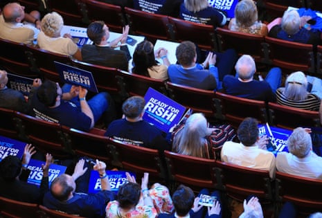 Members of the audience at the Tory hustings holding Ready for Rishi posters.