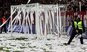 Security personnel clear the box from toilet paper thrown by fans in protest.