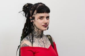 A woman with tattos poses for a photograph International Tattoo Festival