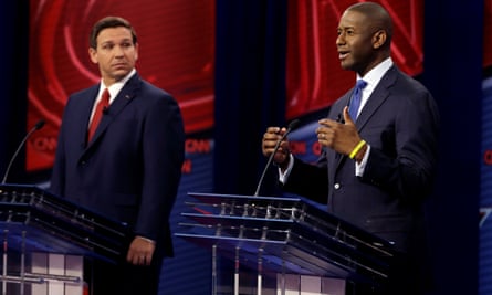 Ron DeSantis looks on as Andrew Gillum makes a point in a debate in Tampa.