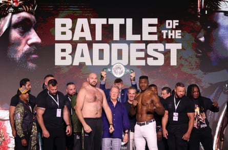 Tyson Fury and Francis Ngannou pose on the stage during the weigh-in