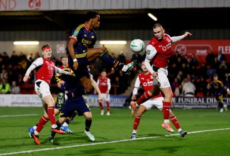 Arsenal's Jurrien Timber jumps to kick the ball above a Fleetwood Town opponent