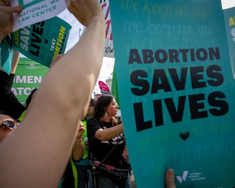 Protesters hold signs reading "Abortion Saves Lives" outside the supreme court