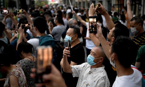 People gather to take pictures outside the US consulate in Chengdu, south-western China.