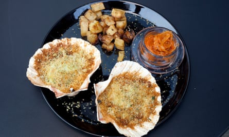 ‘Grilled under thick drifts of buttery golden breadcrumbs’: scallops.