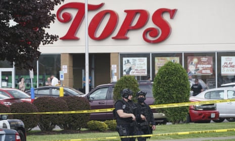 Police secure an area around a supermarket in Buffalo, New York where 10 people were killed in a shooting. 