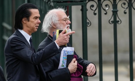 Cave (L) and former archbishop of Canterbury Rowan Williams speak before taking their seats.