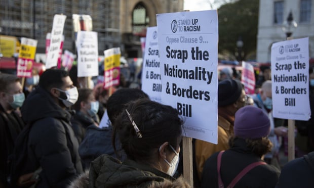 Activist groups holding banners gather to protest against the Nationality and Borders Bill