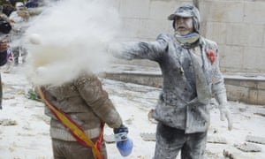 A reveller throws eggs and flour to another participant as they take part in the “Enfarinats” battle in the southeastern Spanish town of Ibi