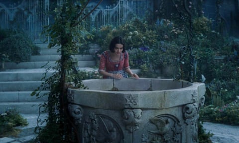 film still of woman looking into a well at twilight