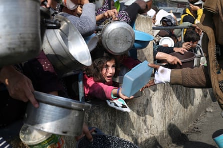 Palestinians line up for food aid in Rafah, 9 January 2024.