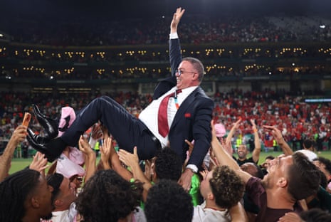 Morocco's head coach Mohamed Ouahbi, is tossed into the air by his players after their penalty shoot-out victory.