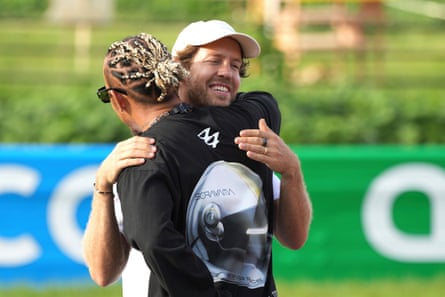 Sebastian Vettel greets Lewis Hamilton as they attend the project which aims to raise awareness of biodiversity.