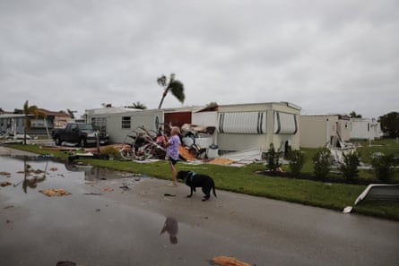 A resident at a mobile home park checks homes in Fort Myers, Florida, on Thursday, one day after Hurricane Ian made landfall.