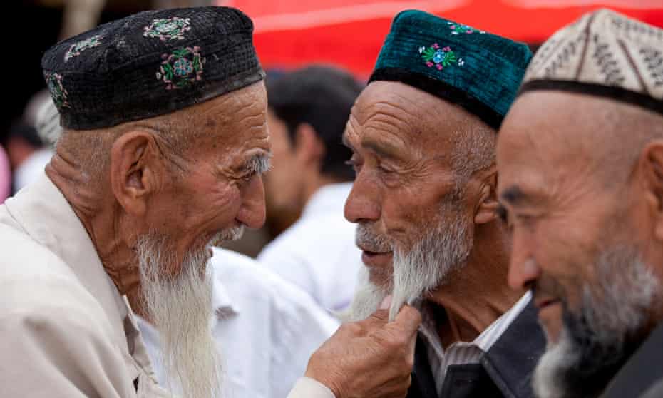 Uighur men in conversation in Xinjiang