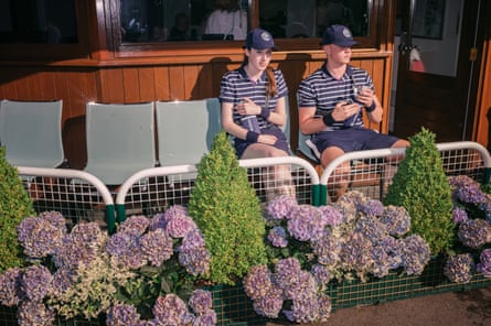 A ball girl and ball boy take a break