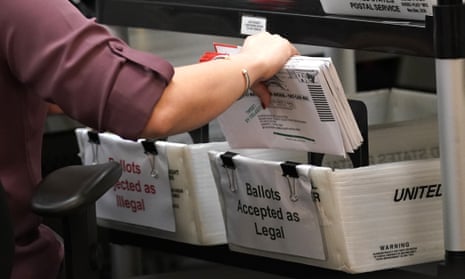 election worker sorts vote-by-mail ballots at the Miami-Dade County Board of Elections