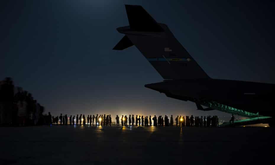 Evacuees wait to board a US Air Force plane at Kabul airport