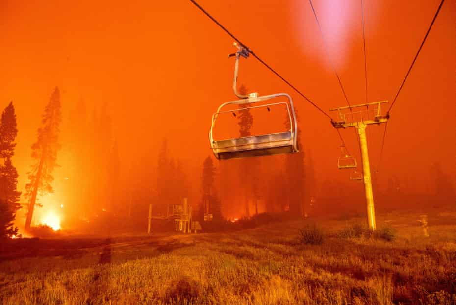 Flames from the Caldor fire surround a chairlift at the Sierra-at-Tahoe ski resort on August 29.