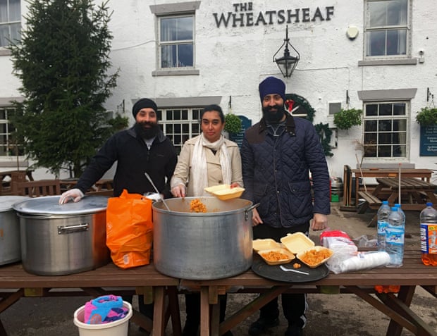 Volunteers from Khalsa Aid, giving out food to villagers in the flood-hit Lancashire village of Croston.