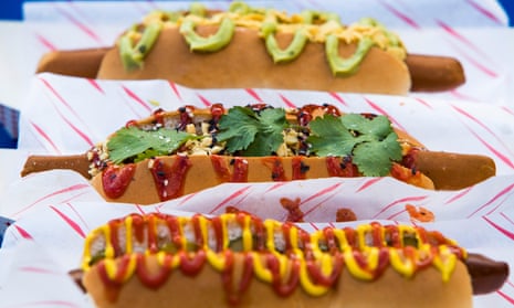 Three vegan hot dogs, street food stall.
