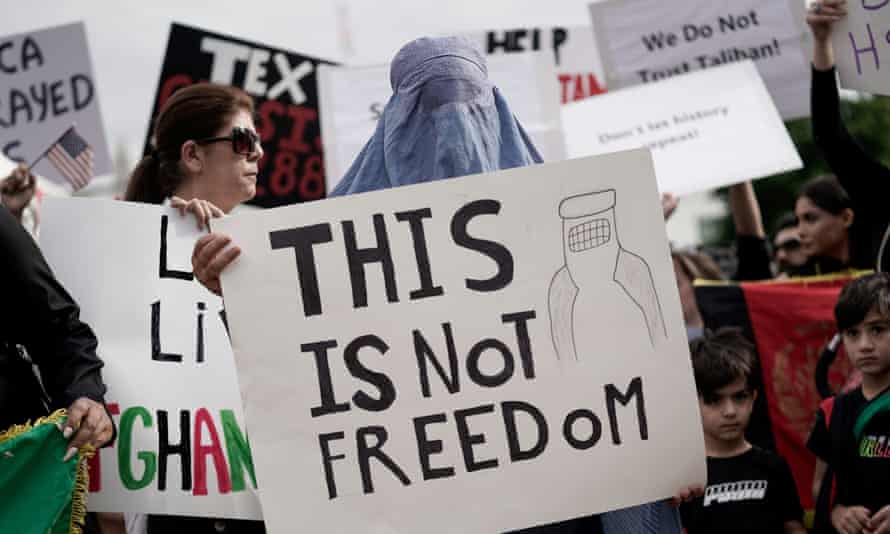 Demonstrators in the United States hold a 'This is not freedom' sign, as the Taliban took hold of Afghanistan for the first time in 20 years on Sunday