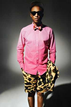 Pharrell combines quarter length shorts with bow tie and shirt.