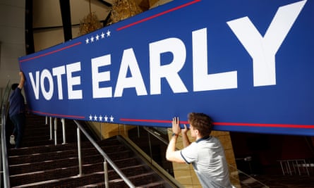 Donald Trump rally staff hold a sign that reads ‘vote early’