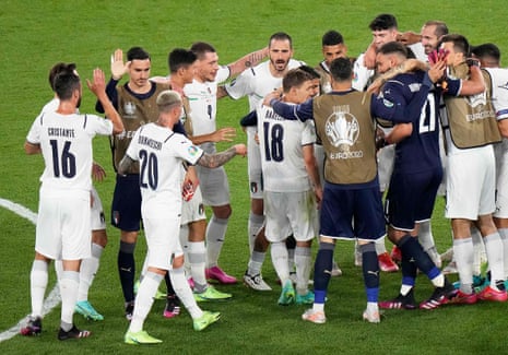 Italy’s players celebrate their victory at the end of the game.