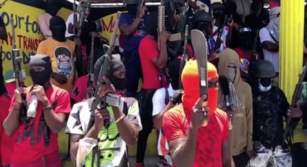 Gang members in Port-au-Prince wearing colourful clothing and balaclavas wielding machetes and guns