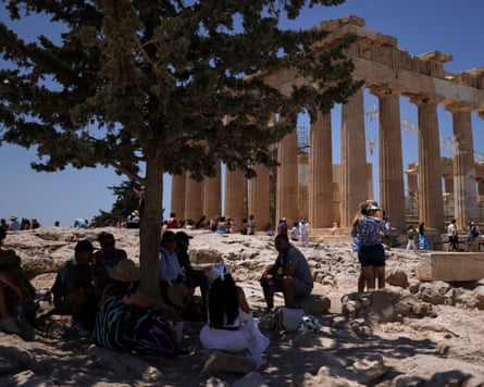 Tourists shelter in the shade at the Parthenon