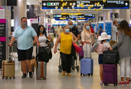 Travelers wearing face masks at Miami airport last week.