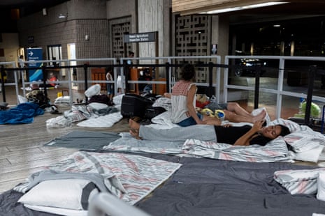 Tourists with makeshift sleeping arrangements wait to leave the island of Maui at the Kahului Airport, Hawaii.