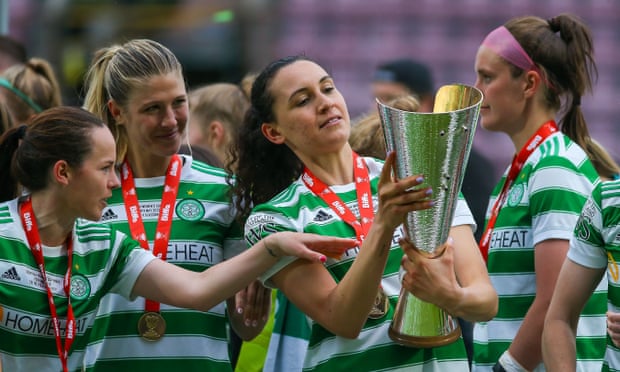 Celtic players admire the Scottish Cup after their victory against Glasgow City.